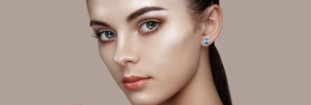 rosto de Mulher jovem com pele saudável e com brilho sobre fundo rosa perolado